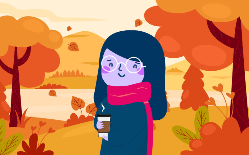 Cartoon character donned in a big scarf, holding a to-go cup of a warm beverage, strolling through an autumnal park setting.